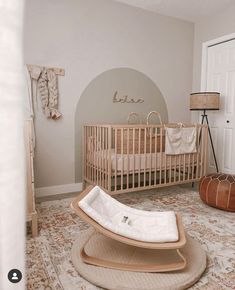 a baby's room with a rocking chair and crib