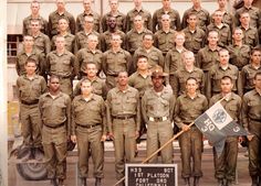 a group of men in uniforms posing for a photo