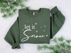 Christmas Sweatshirt - Holiday Sweatshirt - Women's Christmas Shirt - Let it Snow Shirt - Christmas Sweater This sweatshirt is perfect for your Christmas Wardrobe!  These are a Unisex fit and will be a looser fit compared to Women's sizing.  Also,  print can be Black, Red, Green , or White. Typically a Gildan brand sweatshirt will be used. Availability can change throughout the holiday seasons depending on the color you select, so another brand such as Jerzees or Hanes may be used. Sizing will b Let It Snow Shirt, Christmas Wardrobe, Womens Christmas Shirts, Holiday Sweatshirt, Branded Sweatshirts, Let It Snow, Christmas Women, Christmas Shirt, Christmas Sweatshirts