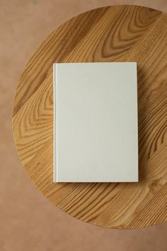 a white book sitting on top of a wooden table