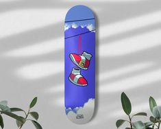 a skateboard with a cartoon character on it next to some plants and a potted plant