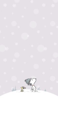 a person walking across a snow covered field next to a small bird on the ground