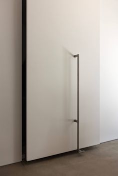 an open door in a white room next to a wall