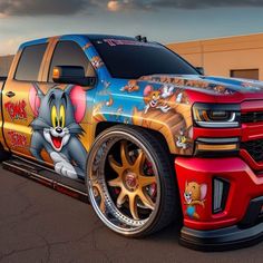 the truck is painted with cartoon characters on it's sides and has gold rims