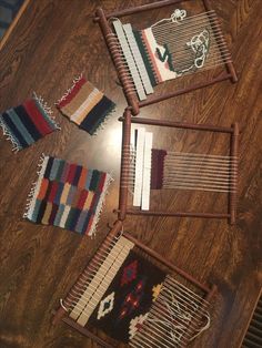 four pieces of weaving sitting on top of a wooden table