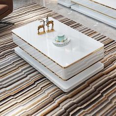 a white coffee table sitting on top of a rug