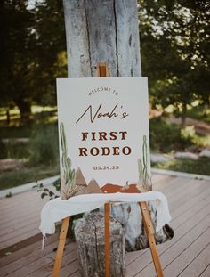 a sign that is on top of a wooden easel in front of a tree