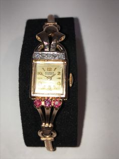 "14 Kt rose gold ladies wristwatch features diamonds and rubies with a different style lug on each side. This art deco fashion watch features a matching 14 kt rose gold snake style band that is a little over 6.5\", it will fit a 6.25\" and smaller wrist comfortably. The mechanical 17 jewel movement runs great and makes this beautiful timepiece ready to wind and wear. Truly a unique way to wear the time that is fashionable as well as functional." Formal Rose Gold Watches With Jubilee Bracelet, Rose Gold Diamond Watch With Round Dial For Evening, Elegant Pink Gold Watch For Formal Occasions, Formal Pink Diamond Watch With Diamond Hour Markers, Elegant Pink Diamond Watch, Pink Diamond Watch With Round Dial For Formal Events, Pink Diamond Watch With Round Dial For Formal Occasions, Classic Pink Diamond Watch For Formal Occasions, Deco Fashion