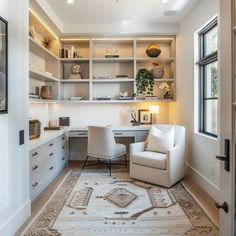 a white chair sitting next to a desk in a room with lots of shelves on the wall