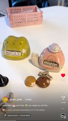 two alarm clocks sitting on top of a table next to other items that are in the shape of animals