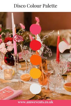 the table is set with candles, flowers and other decorations for a party or celebration