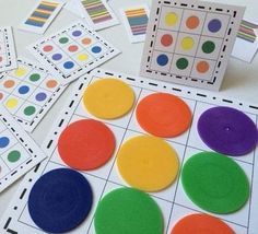 several different colored circles and squares are on the table with matching cards to match them