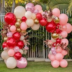 an arch made out of balloons and flowers