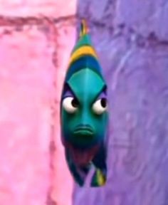 an animated fish with big eyes hanging from the side of a purple and pink wall