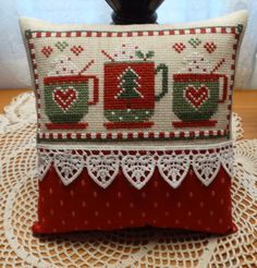 a red and white pillow sitting on top of a table