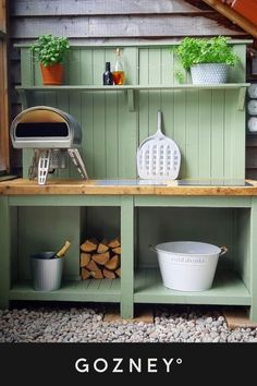 an outdoor bbq with potted plants and cooking utensils on the shelves