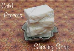 three cubes of soap sitting on top of a green plate with the words cold process shaving soap