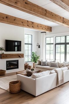 a living room filled with furniture and a flat screen tv mounted on the wall next to a fire place