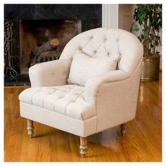 a white chair sitting in front of a fire place