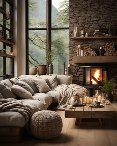 a living room filled with furniture and a fire place in front of a large window