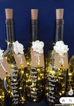 wine bottles are decorated with lights and tags for the guests to put on their wedding day