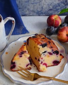 a piece of cake sitting on top of a white plate next to a cup of coffee