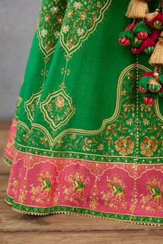 Rich green kalidar lehenga with digital bhagalpuri print, hand adda work and gota embroidery. Comes with matching half sleeve blouse and sheer pink dupatta.
Components: 3
Pattern: Embroidery and Print
Type Of Work: Hand Adda Work, Gota and Digital Bhagalpuri Print
Neckline: Leaf
Sleeve Type: Half
Fabric: Heavy Raw Silk and Silk Organza
Color: Green,Pink
Other Details: 
Dupatta with rich green printed border and cutwork detailing
Cutout at the back
Closure: Side zip
Occasion: Sangeet - Aza Fashio Gota Embroidery, Leaf Sleeve, Pink Dupatta, Types Of Work, Half Sleeve Blouse, Green Hand, Pattern Embroidery, Rich Green, Silk Organza