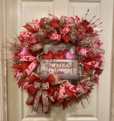 a valentine's day wreath hanging on the front door