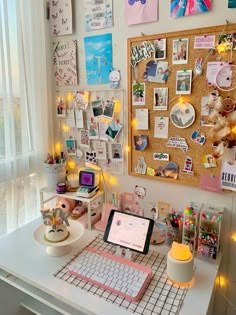 a white desk topped with a laptop computer next to a wall covered in magnets