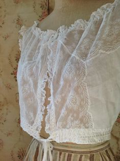 "breath taking fresh antique camisole, wedding top. sleeveless lace summer top in excellent condition. bust 92 cm 36\" waist 66 cm 26\" length 38 cm 15\" the shoulders have ruffled lace and made on them you can see see little roses made of soft silk ribbons" Underbust Lace Bodice With Lace Trim, Lace Underbust Bodice For Wedding, Lace Underbust Camisole With Lace Trim, White Lace Bodice With Lace Trim, White Lace Trim Bodice For Wedding, White Lace Trim Wedding Bodice, Lace Camisole With Lace Trim For Daywear, Lace Trim Camisole For Daywear, Fitted Camisole Blouse For Daywear