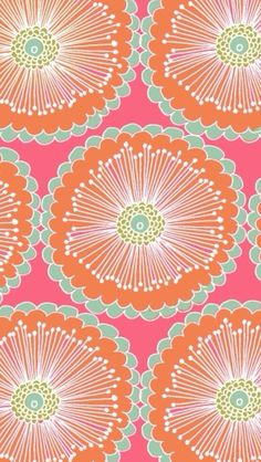 an orange and green flower pattern on a pink background with white flowers in the center