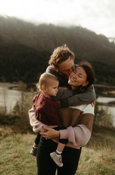 a woman holding two children in her arms