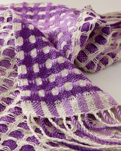 a purple and white checkered scarf on a table