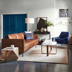 a living room filled with furniture and a blue door