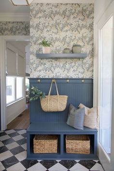 a blue bench with baskets on it in front of a checkered floor and wall