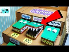 an open cardboard box filled with different types of decorated cookies in the shape of monsters