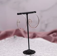 These earrings are unique in shape and size. They are made of sterling silver, which is a durable and beautiful metal. The combination of the unique shape and the sterling silver makes for a pair of earrings that will make a beautiful addition to your jewelry collection!