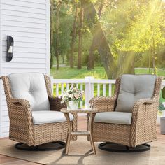 two wicker chairs sitting on a porch next to a table with flowers in it