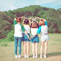 four girls standing in a circle with their hands together