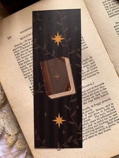 an open book with a brown cover and gold stars on it