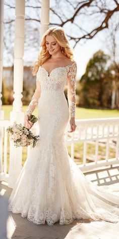 a woman in a wedding dress standing on a porch