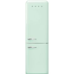 a mint green refrigerator freezer sitting on top of a white counter next to a wall