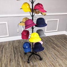 several hats are arranged on a hat rack