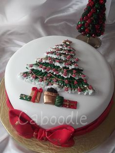 a decorated christmas cake sitting on top of a table