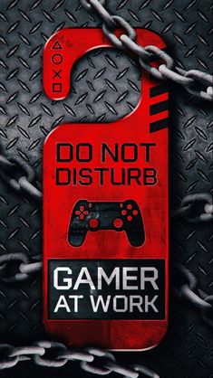 a red sign that says, do not disturb gamer at work