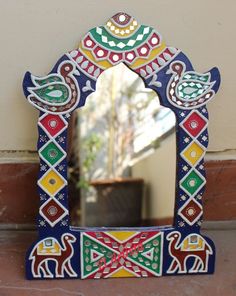 a colorful mirror with an elephant design on it