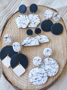 marble and black earrings on a wooden tray