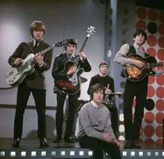 the beatles on stage with their guitars