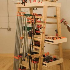 a man standing next to a ladder with tools on it