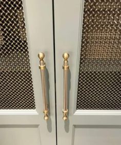 two white doors with gold handles on each side and one has a metal door handle